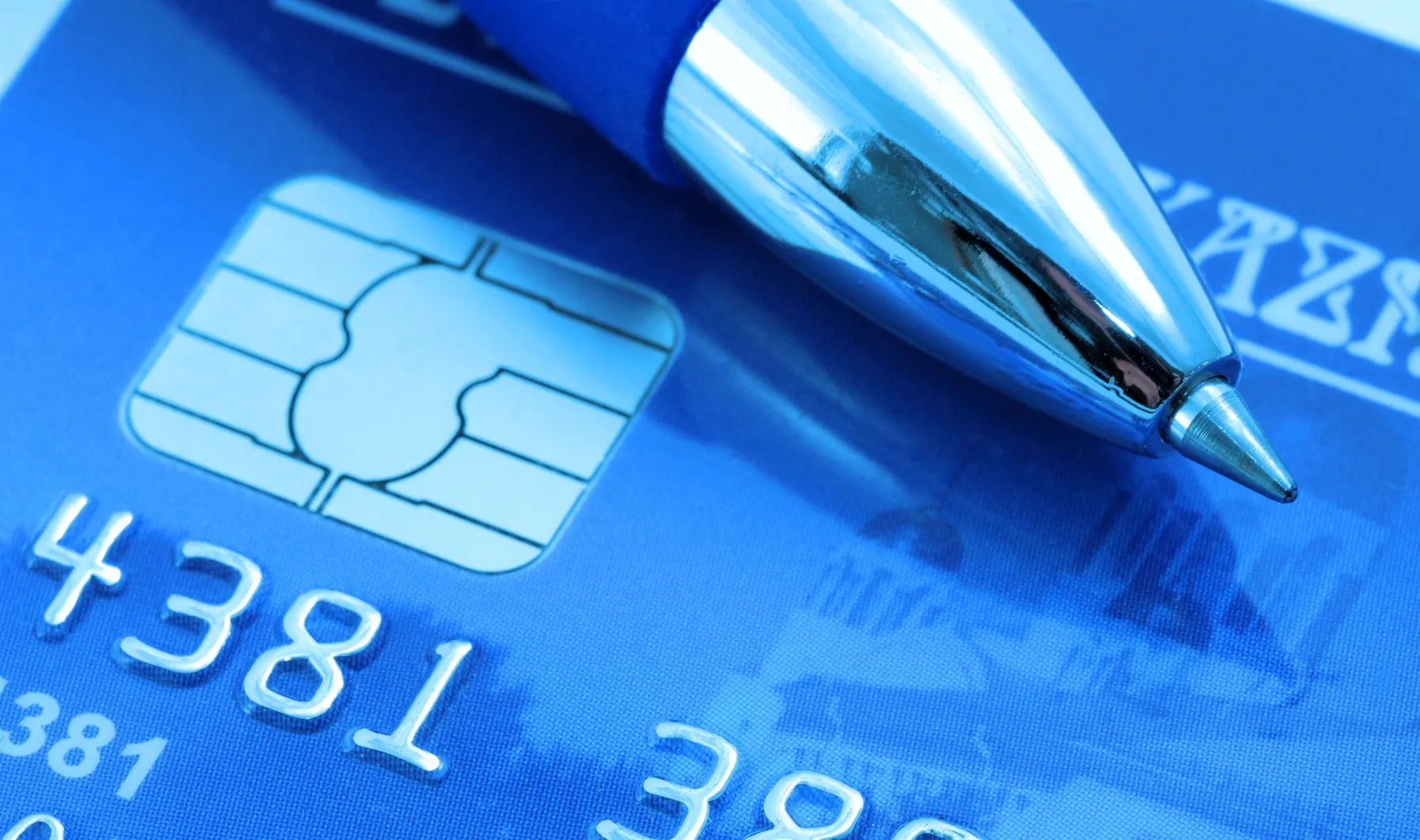 Credit card with chip and pen close-up